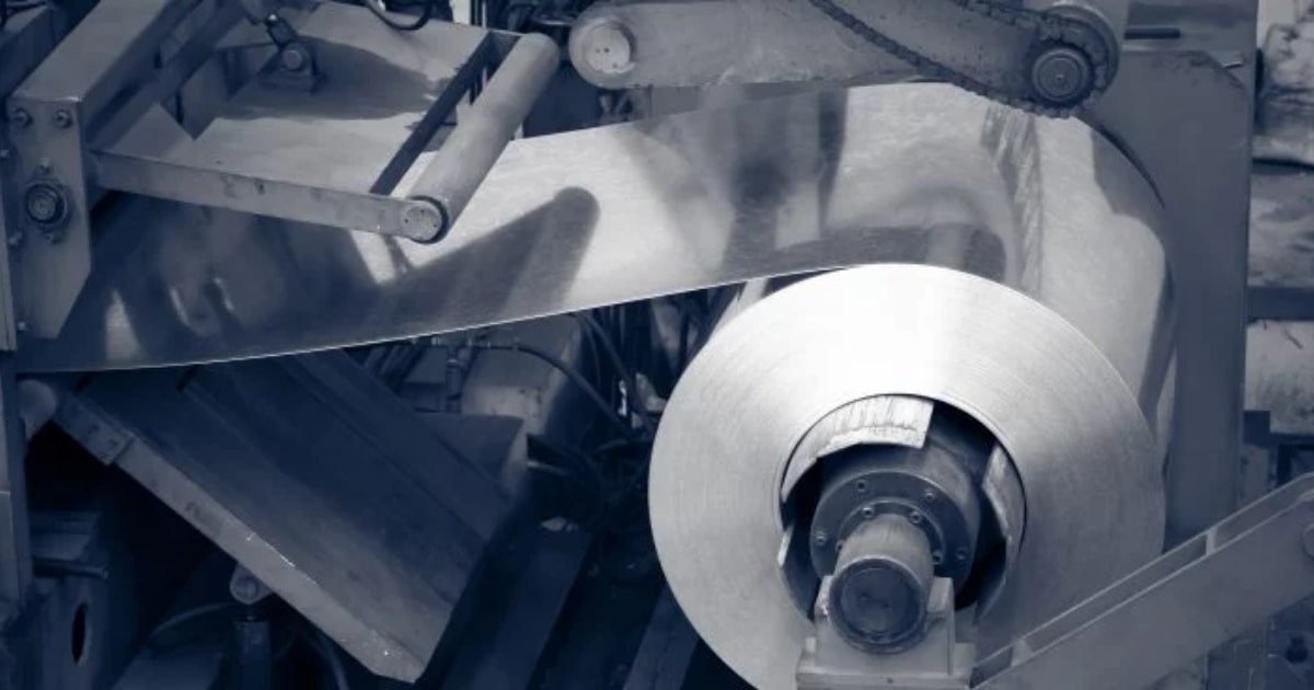 Aluminium flat rolled products being processed on an industrial rolling machine at OZBROS manufacturing facility.